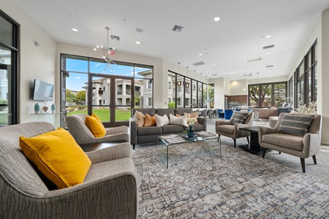 a living room with couches and chairs and a table